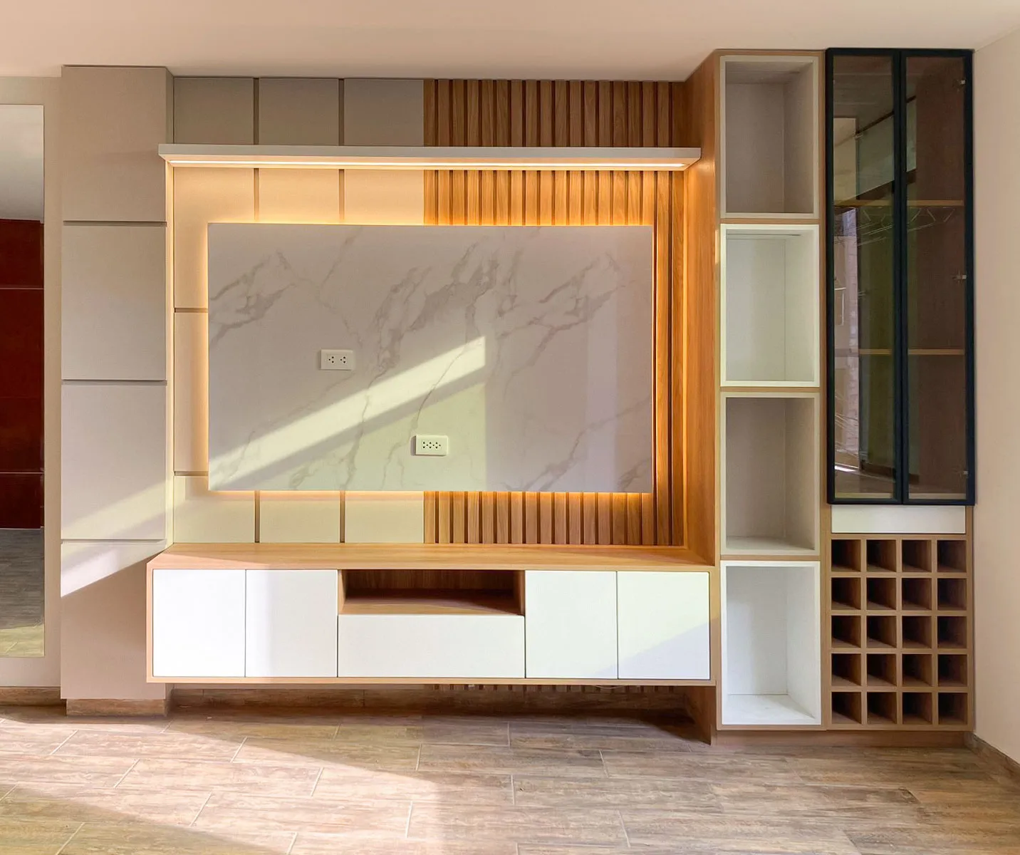 Mueble de sala a medida con marco de luz LED cálida, repisas abiertas y cava de vino en madera — Santiago de Surco